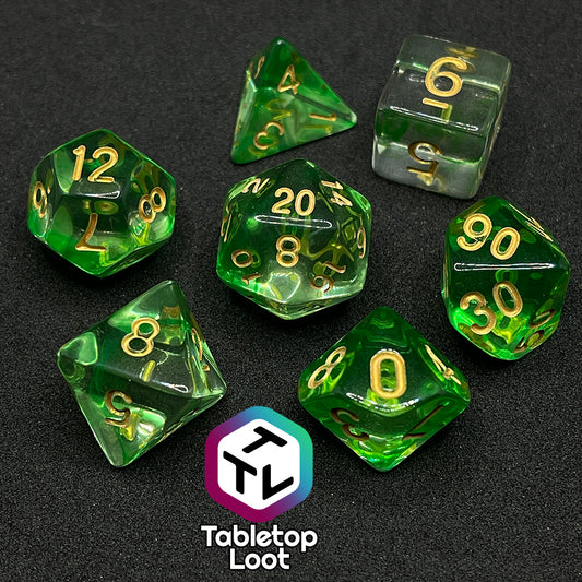 The Aura of the Traveler 7 piece dice set from Tabletop Loot with swirls of lime green in clear dice with gold numbering.