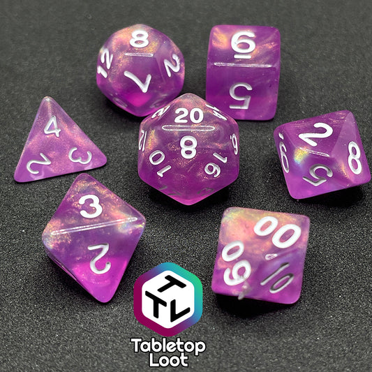 The Dreamscapes 7 piece dice set from Tabletop Loot; pink with iridescent glitter and white numbering.