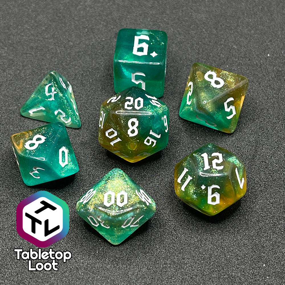 The Fey Moss 7 piece dice set from Tabletop Loot with swirls of glittery green and yellow and white bold gothic numbering.