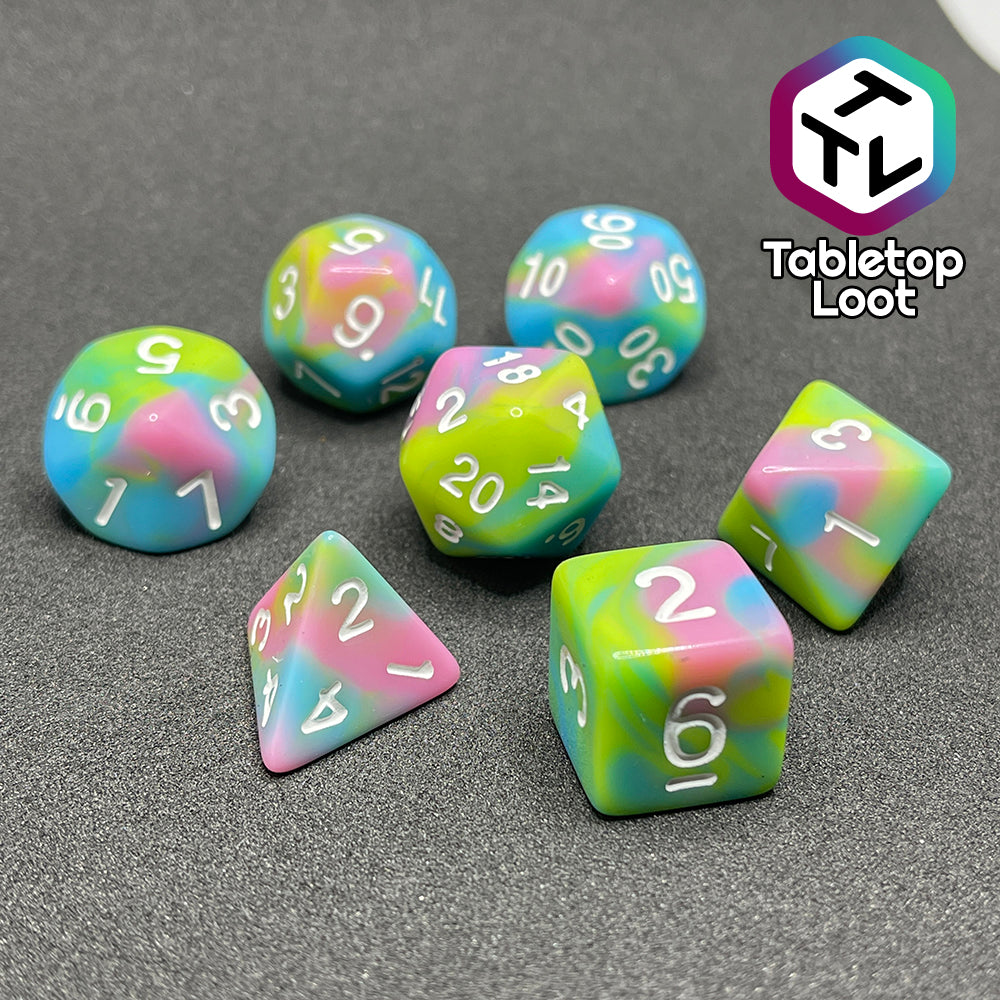 The Jawbreakers 7 piece dice set from Tabletop Loot with swirls of pink, blue, and green and white numbers.