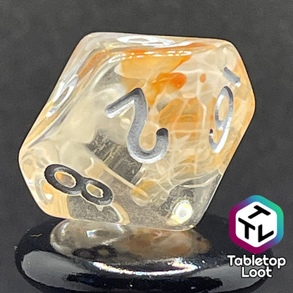 A close up of the D10 from the Hunter's Moon 7 piece dice set from Tabletop Loot with swirls of orange and white in clear resin and white numbering.