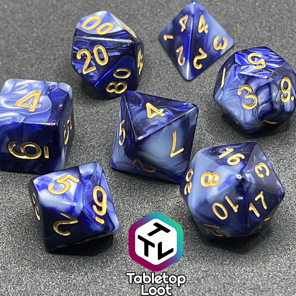 The Order of the Night's Veil 7 piece dice set from Tabletop Loot with swirls of pearlescent purple and white with gold numbering.