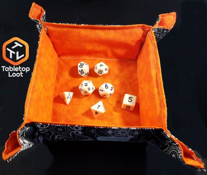 The Bleached Bone 7 piece dice set from Tabletop Loot with matte white resin and black numbering in a dice tray by Aras Sivad Studio.