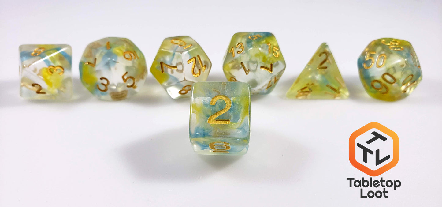 A close up of the D6 from the Nature's Essence 7 piece dice set from Tabletop Loot with swirls of blue and green in clear resin with gold numbering.