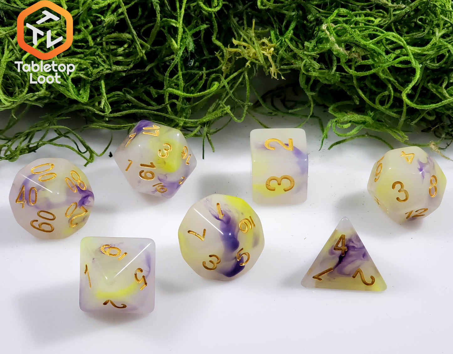 The Fields of Wildflowers 7 piece dice set from Tabletop Loot with swirls of purple and yellow in a milky resin and gold numbering.
