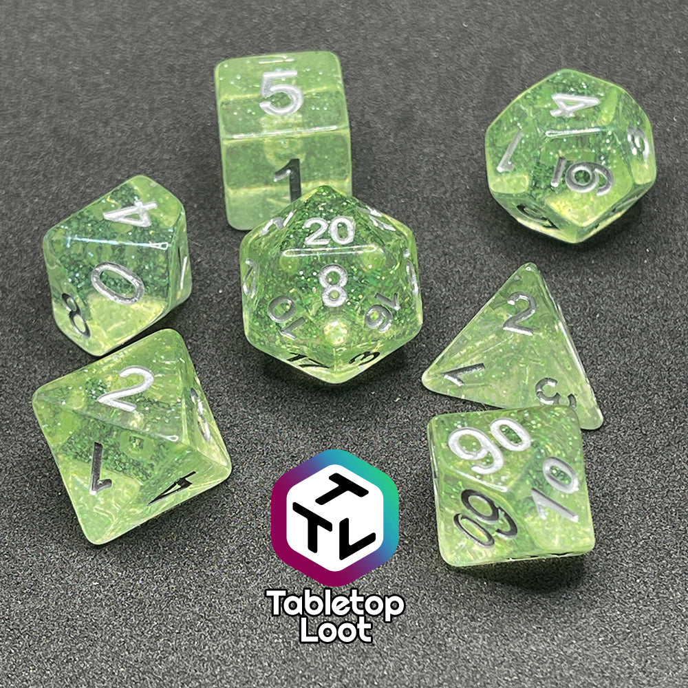 The Acid Splash 7 piece dice set from Tabletop Loot; glittery lime green translucent dice with silver numbering.