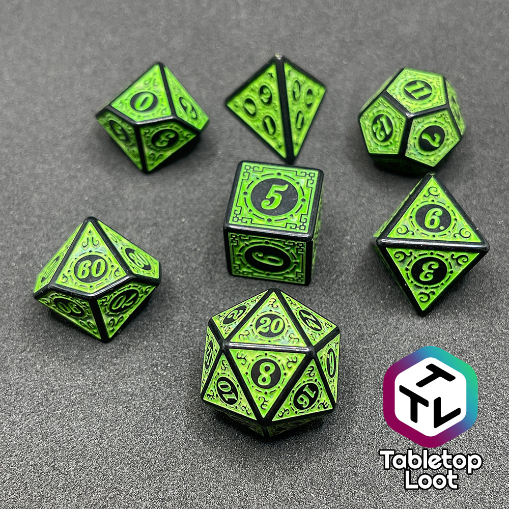 The Artificer's Delight 7 piece dice set from Tabletop Loot with bold, neon green numbers on intricate scrolling black frames that make up each side.