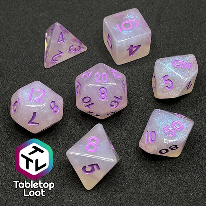 The Astral Projection 7 piece dice set from Tabletop Loot with lavender numbering on milky dice with iridescent shimmer.