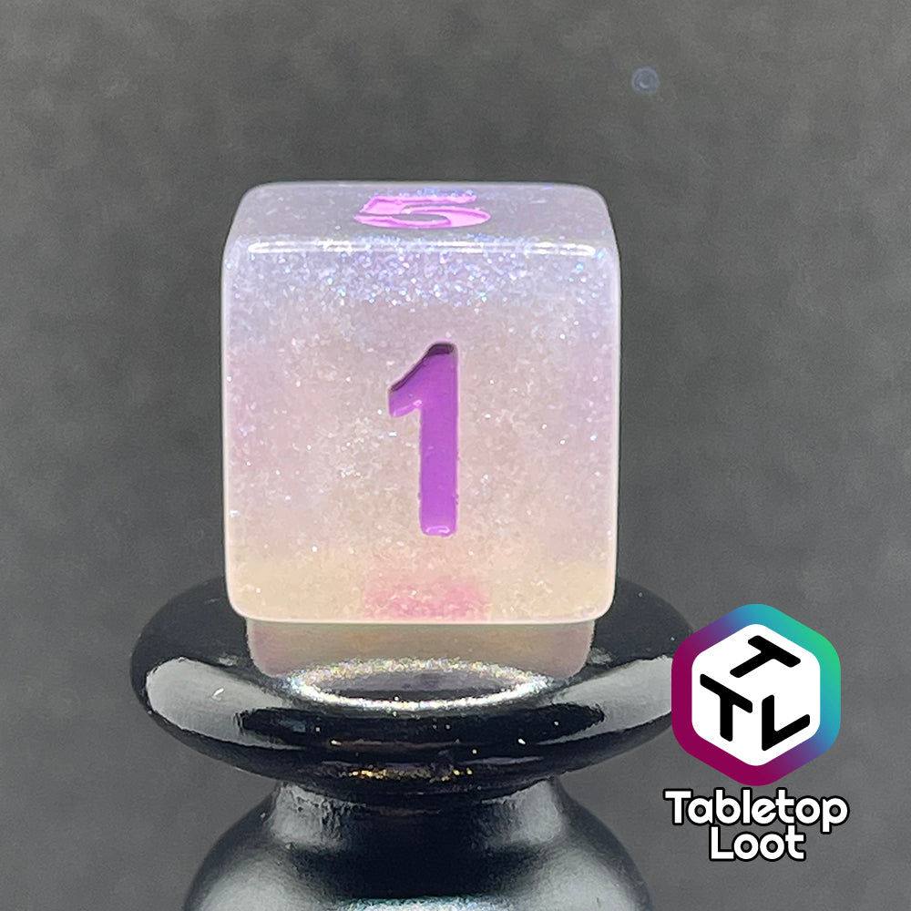 A close up of the D6 from the Astral Projection 7 piece dice set from Tabletop Loot with lavender numbering on milky dice with iridescent shimmer.