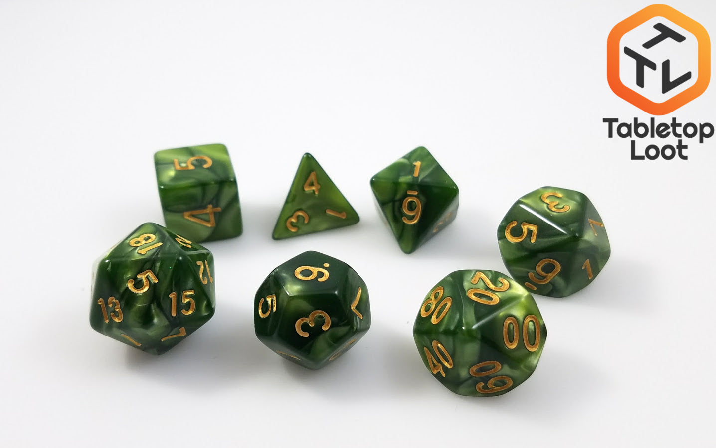 The Bamboo Forest 7 piece dice set from Tabletop Loot with swirls of pearlescent green resin and gold numbering.