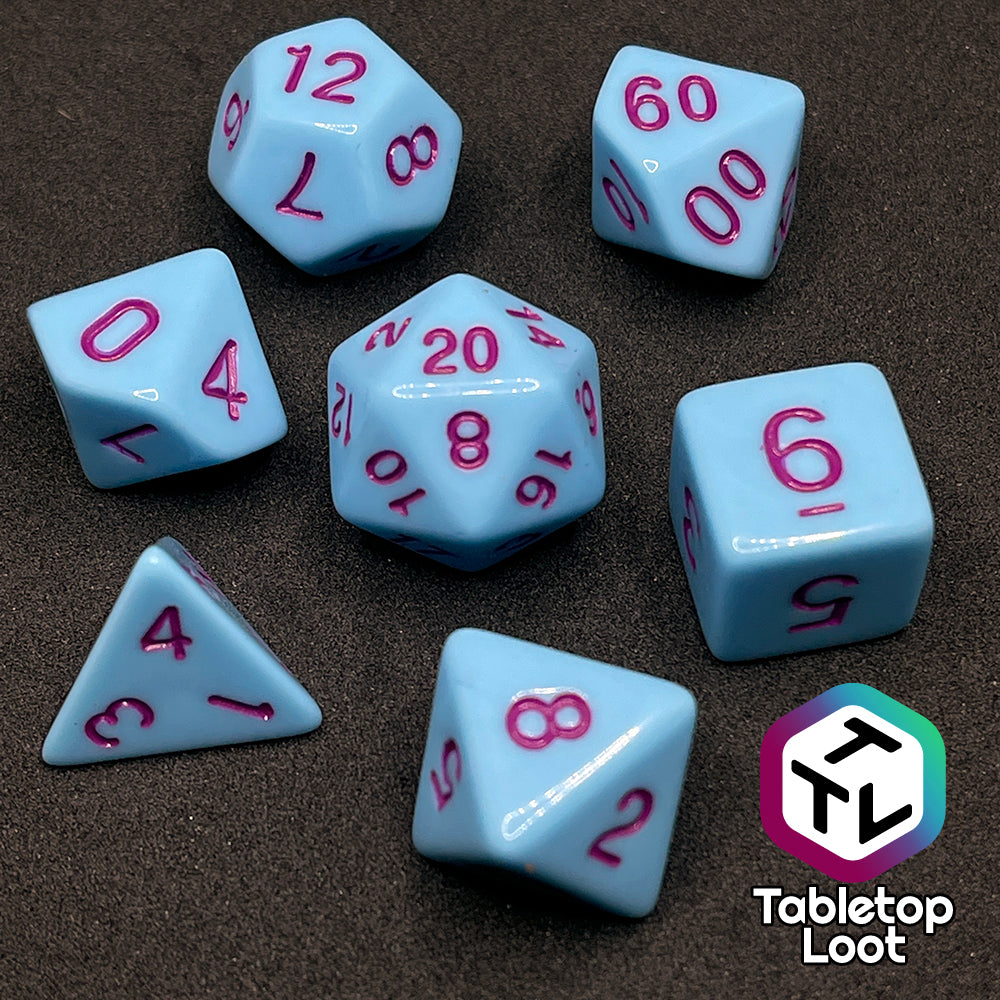 The Bantha Milk 7 piece dice set from Tabletop Loot with purple numbering on solid pastel blue faces.