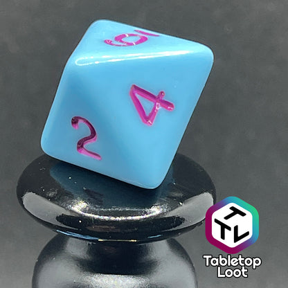 A close up of the D8 from the Bantha Milk 7 piece dice set from Tabletop Loot with purple numbering on solid pastel blue faces.