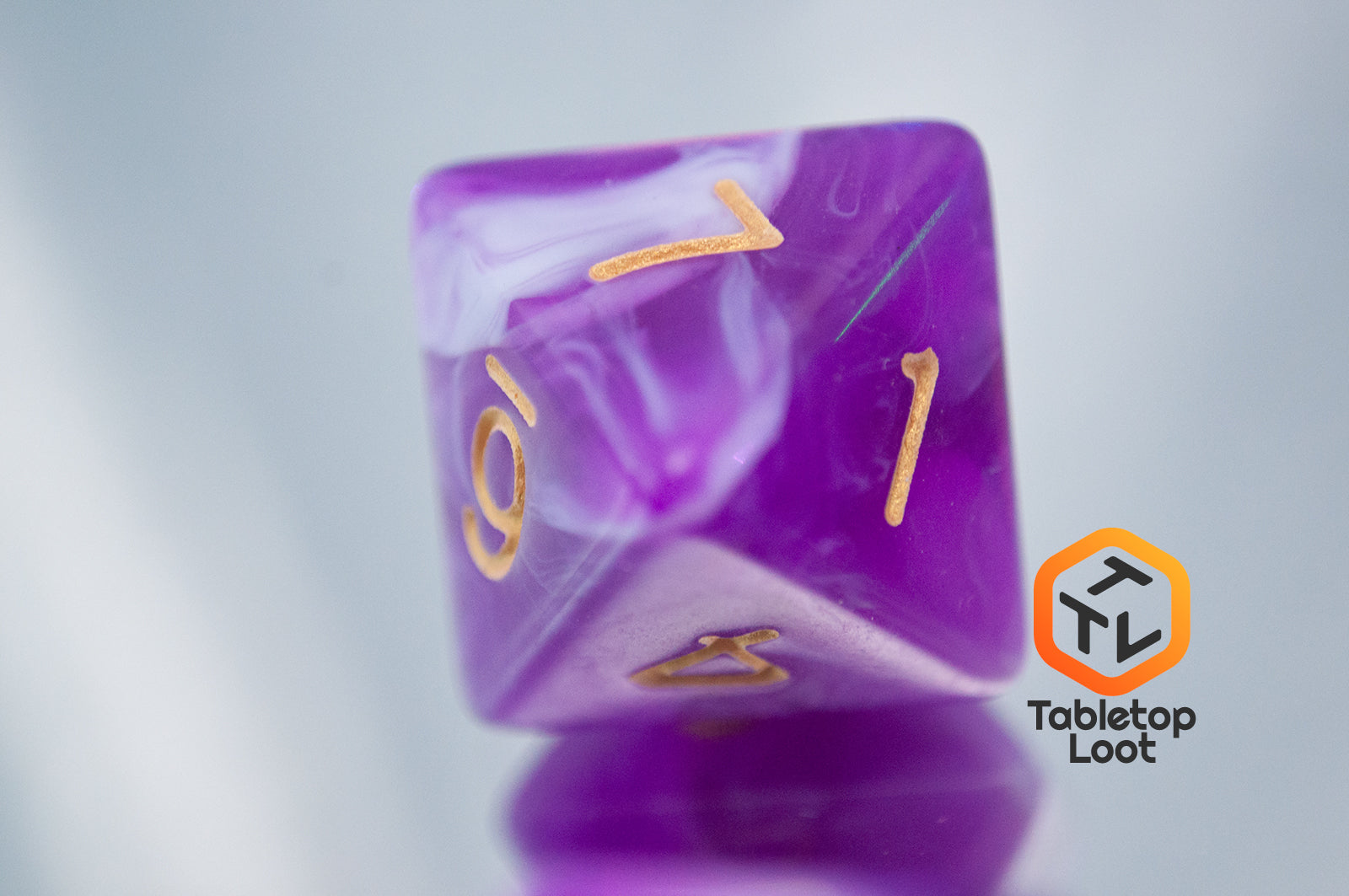 A close up of the D8 from the Berry Blast 7 piece dice set from Tabletop Loot with swirls of purple and white and gold numbering.