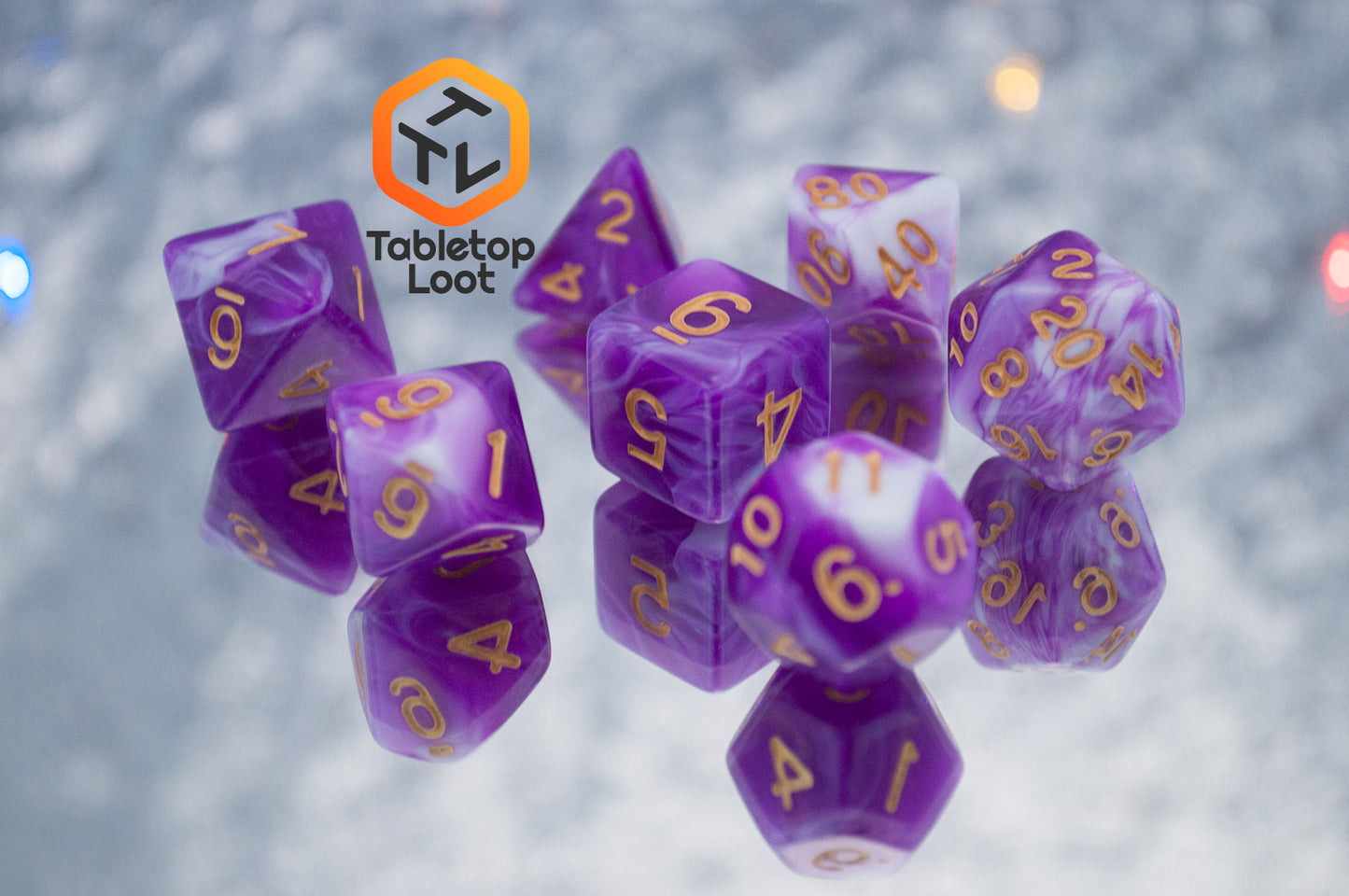 The Berry Blast 7 piece dice set from Tabletop Loot with swirls of purple and white and gold numbering.