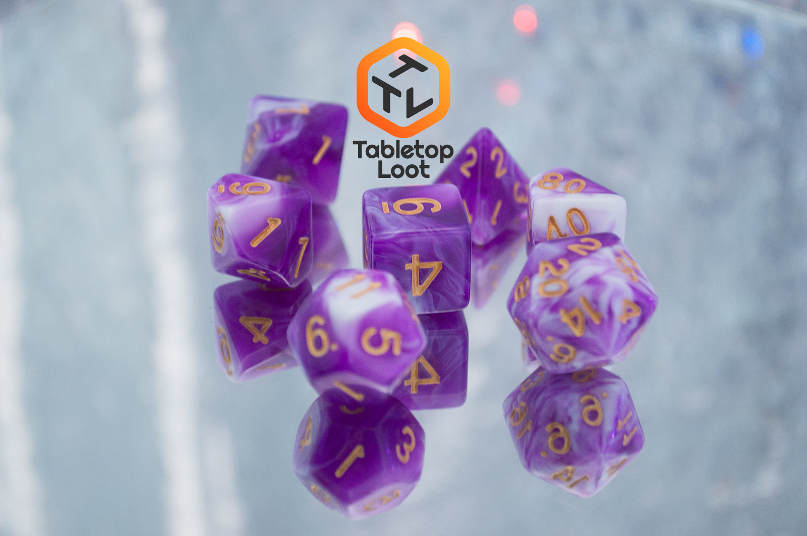 The Berry Blast 7 piece dice set from Tabletop Loot with swirls of purple and white and gold numbering.