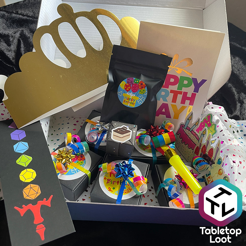 A loot box showing several small boxes wrapped in colorful ribbon surrounded by birthday stickers and card.