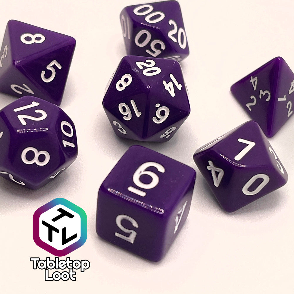 A close up of the Blackberries 7 piece dice set; solid purple with white numbering.