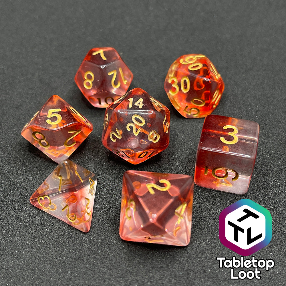 The Blood Hunter 7 piece dice set from Tabletop Loot with swirled red and clear resin and gold numbering.