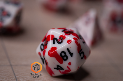 A close up of the D20 from the Tavern Brawl 7 piece dice set from Tabletop Loot with red fake blood on white dice with black numbering.