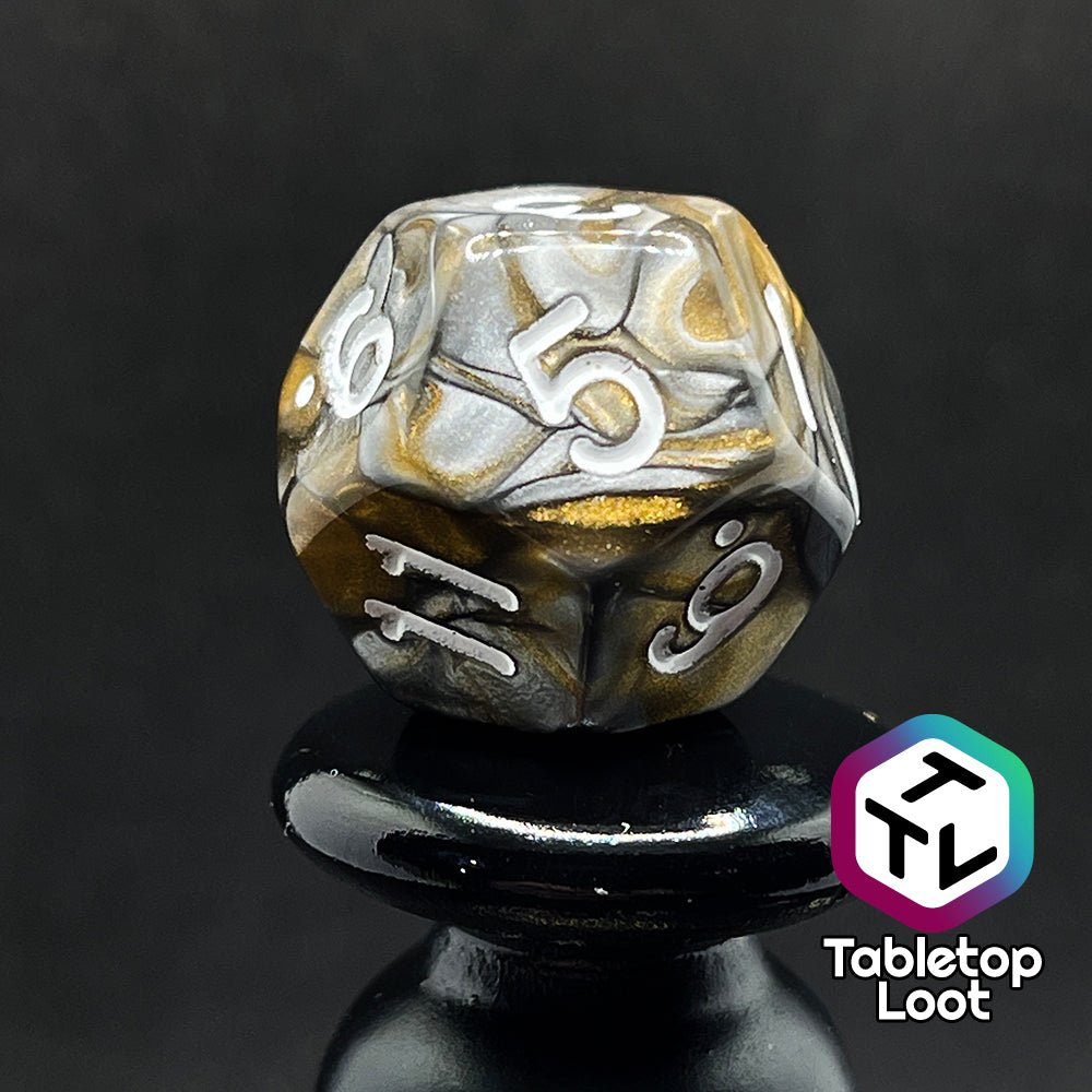 A close up of the D12 from the Bronze Dragon 7 piece dice set from Tabletop Loot with swirls of pearlescent bronze and silver and silver numbering.