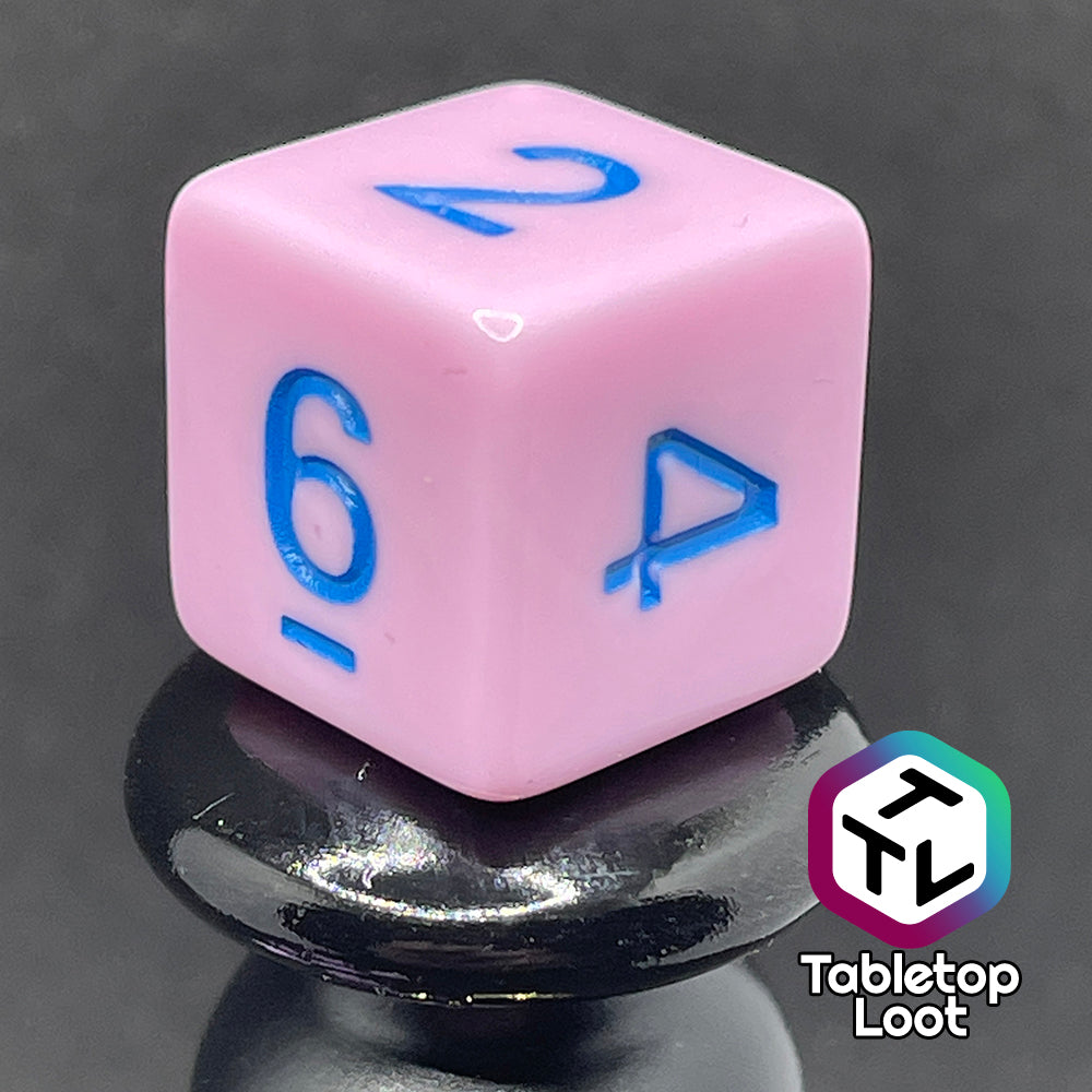 A close up of the D6 from the Berry Bubblegum 7 piece dice set from Tabletop Loot with blue numbering on solid pastel pink sides.