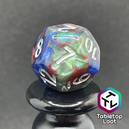 A close up of the D12 from the Changeling 7 piece dice set from Tabletop Loot with swirls of pearlescent red, green, and blue and silver numbering.