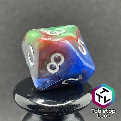 A close up of the D10 from the Changeling 7 piece dice set from Tabletop Loot with swirls of pearlescent red, green, and blue and silver numbering.