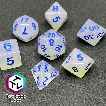 The Clairvoyance 7 piece dice set from Tabletop Loot with royal blue numbering on milky shimmery dice.