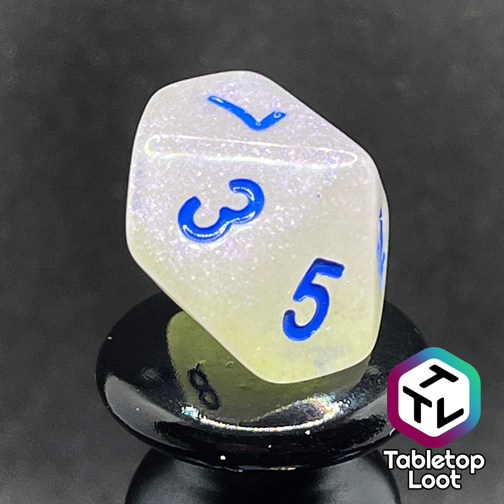 A close up of the D10 from the Clairvoyance 7 piece dice set from Tabletop Loot with royal blue numbering on milky shimmery dice.