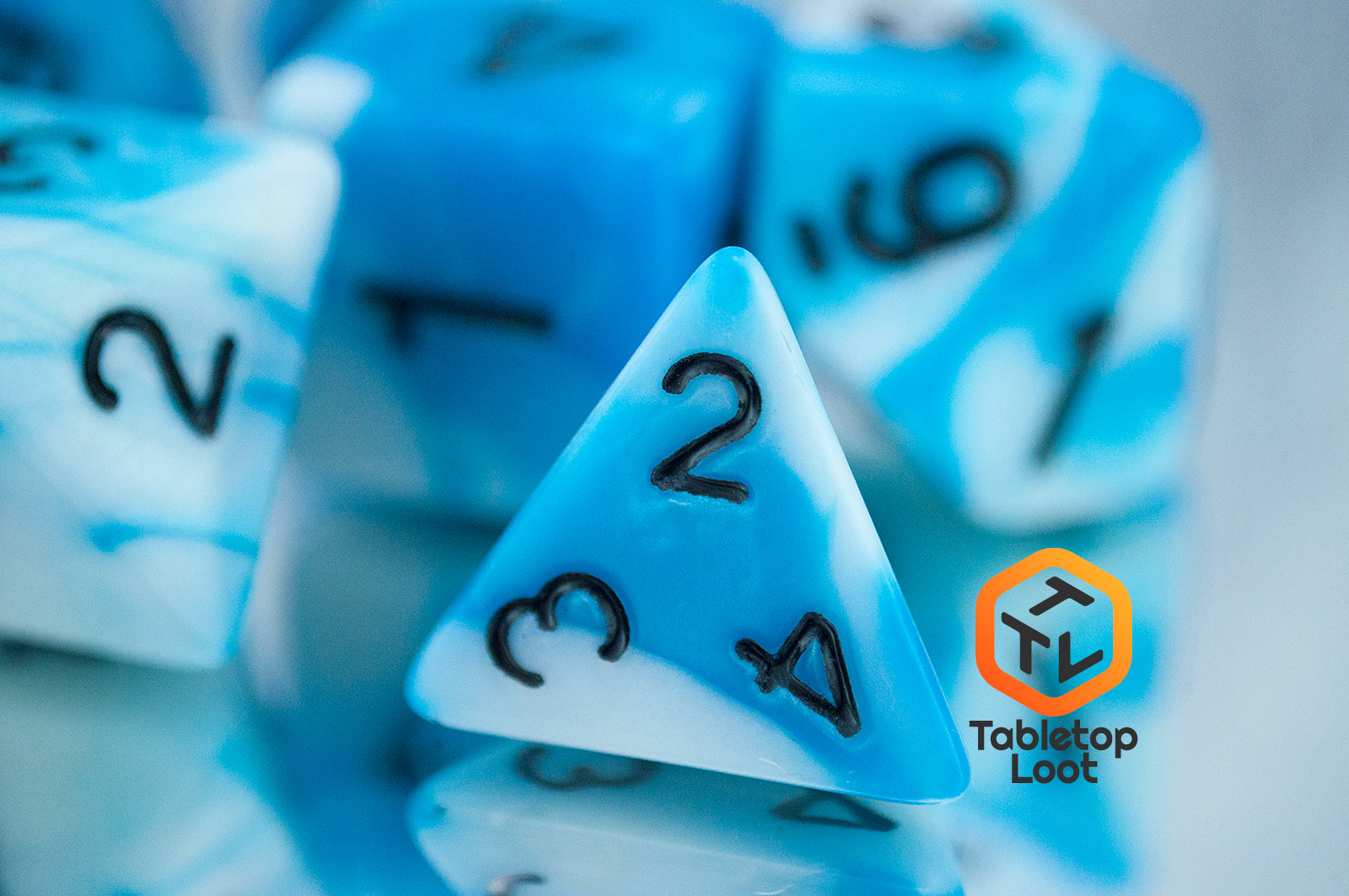 A close up of the D4 from the Cloudy Sky 7 piece dice set from Tabletop Loot with swirls of bright blue and white resin and black numbering.