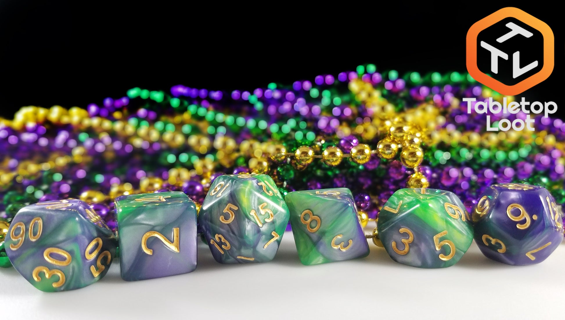 The Commune with Nature 7 piece dice set from Tabletop Loot with swirls of green and purple and gold numbering.