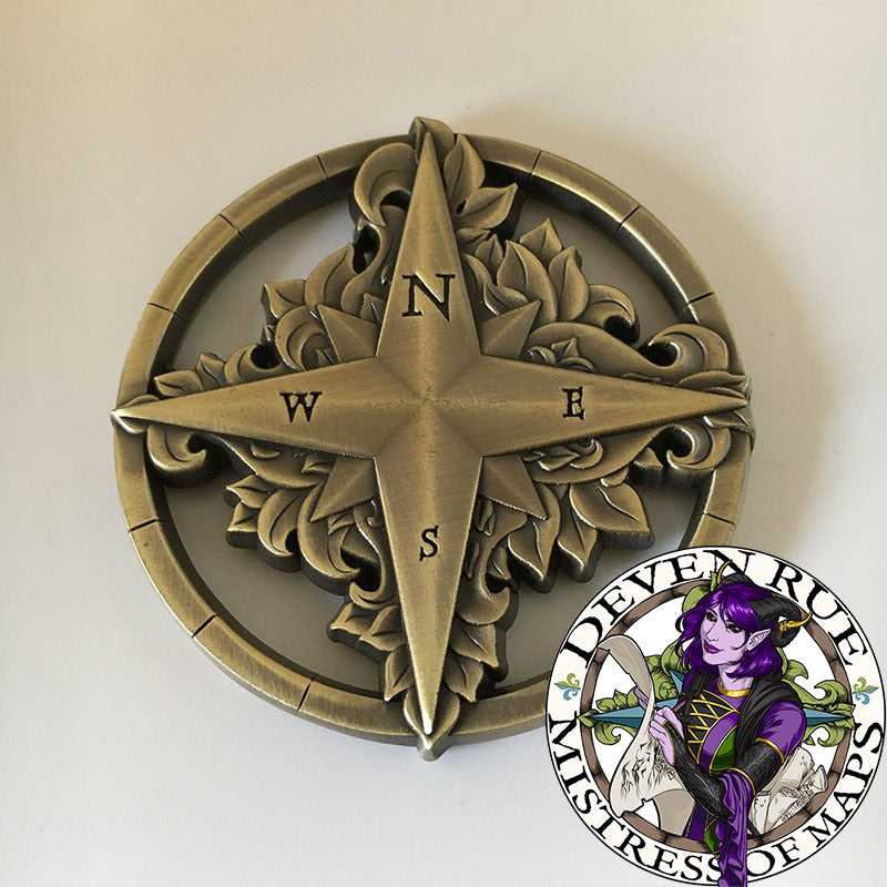 The front of the Compass Rose token map weight by Deven Rue to show the raised details with fine engraving.