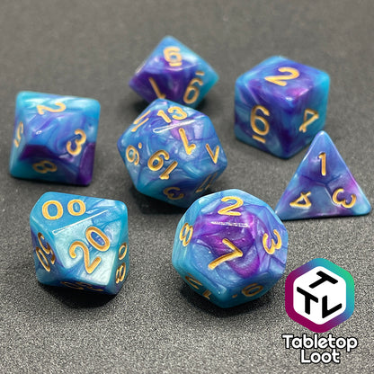 The Cotton Candy 7 piece dice set from Tabletop Loot with swirls of blue and purple and golden numbers.