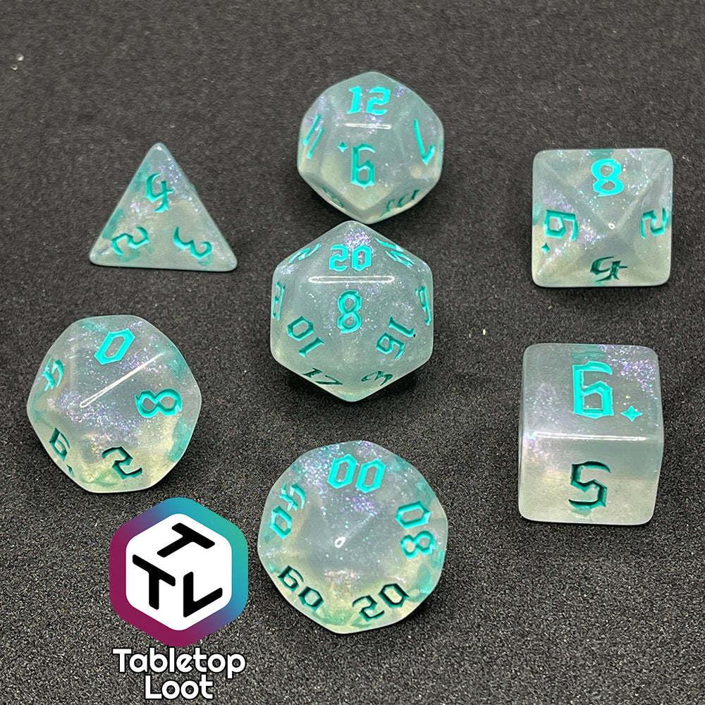 7 piece translucent polyhedral dice set with iridescent micro-glitter and red numbers.