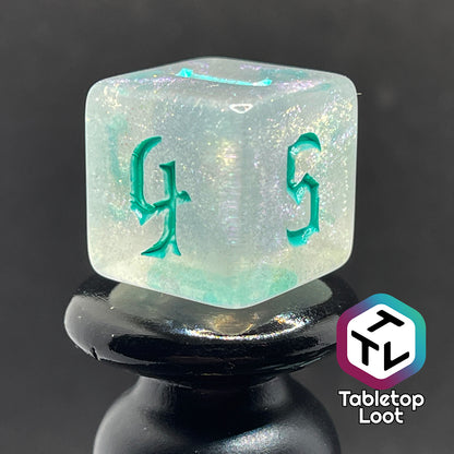 translucent d6 with iridescent micro-glitter and red numbers.