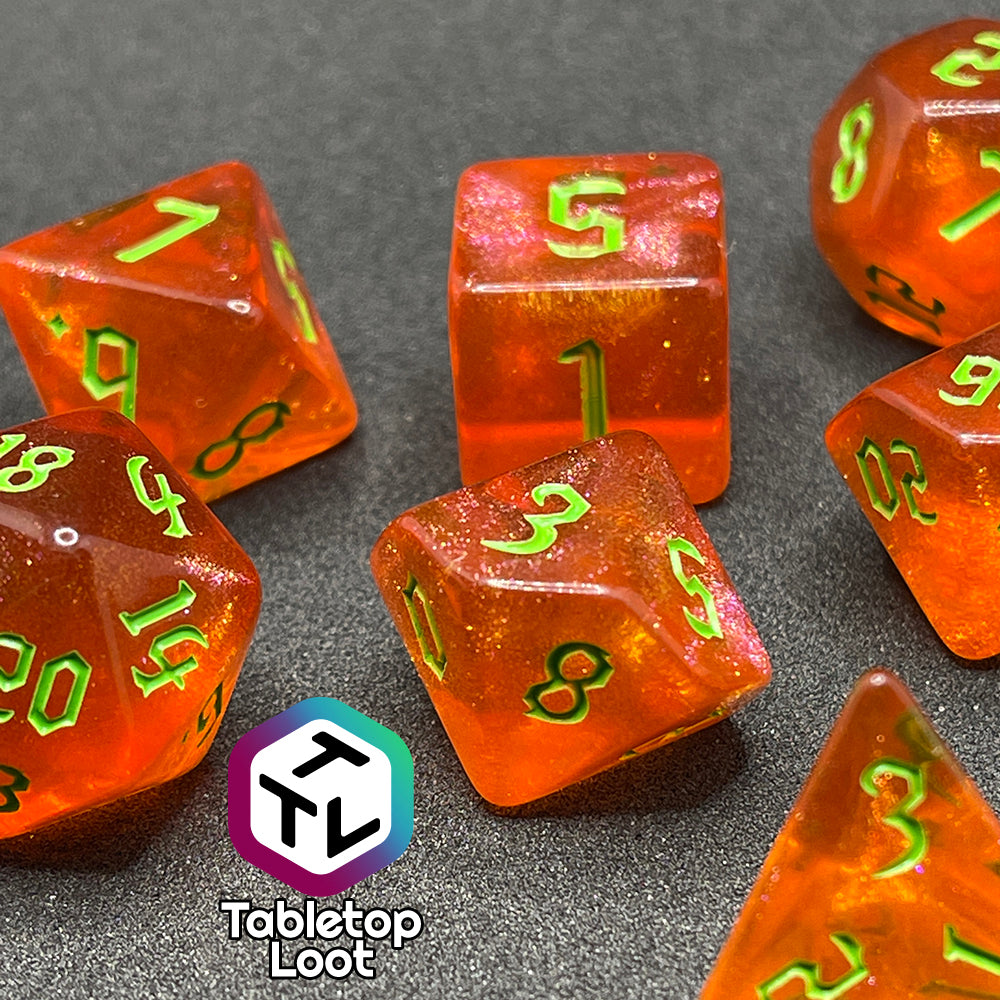 A close up of the Cyber Punk'in 7 piece dice set from Tabletop Loot; glittery orange with neon green gothic numbering.