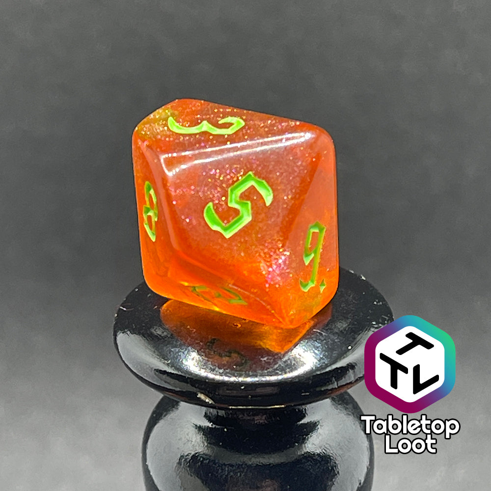 A close up of the D10 from the Cyber Punk'in 7 piece dice set from Tabletop Loot; glittery orange with neon green gothic numbering.