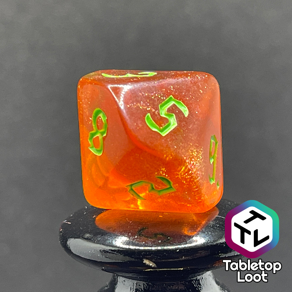 Another close up of the D10 from the Cyber Punk'in 7 piece dice set from Tabletop Loot; glittery orange with neon green gothic numbering.