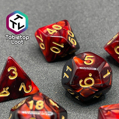 A close up of the Demon Stones 7 piece dice set from Tabletop Loot with swirls of pearlescent red and black and golden numbering.