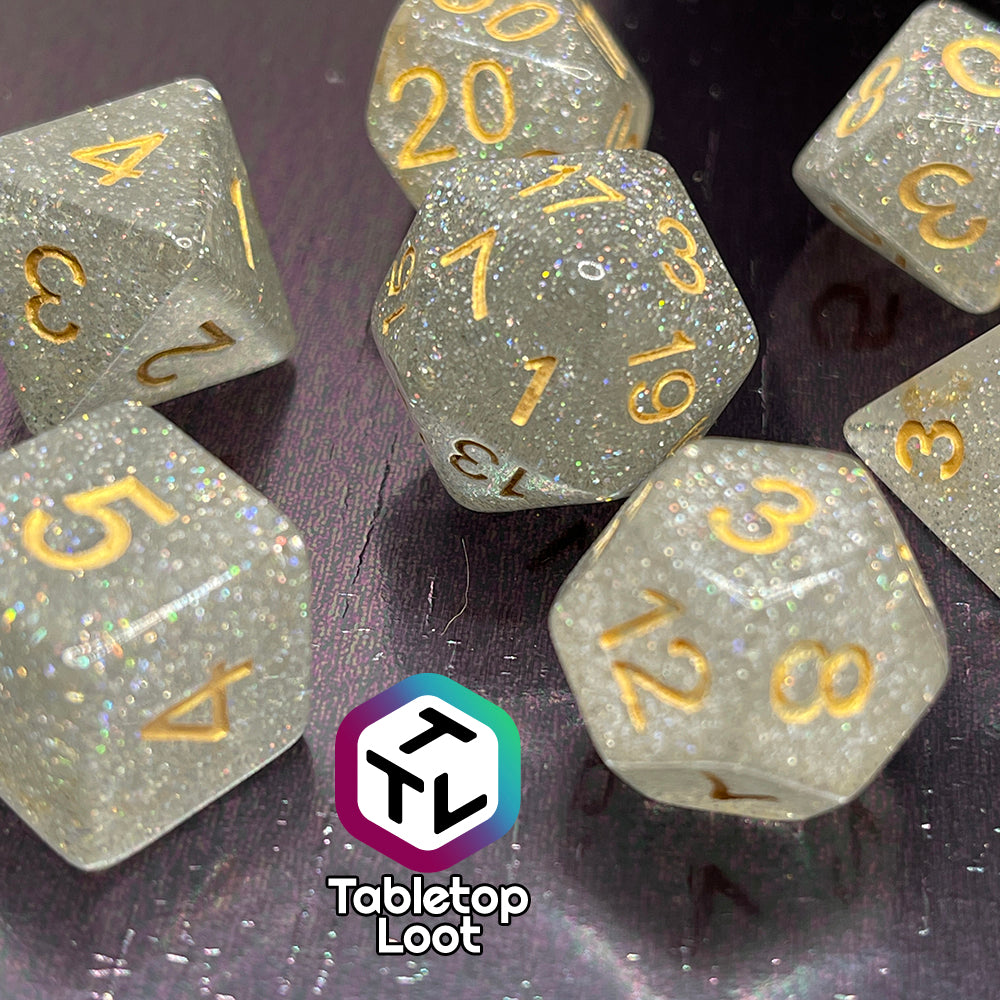 The Diamond Dust 7 piece dice set from Tabletop Loot packed with silver glitter and gold numbering.