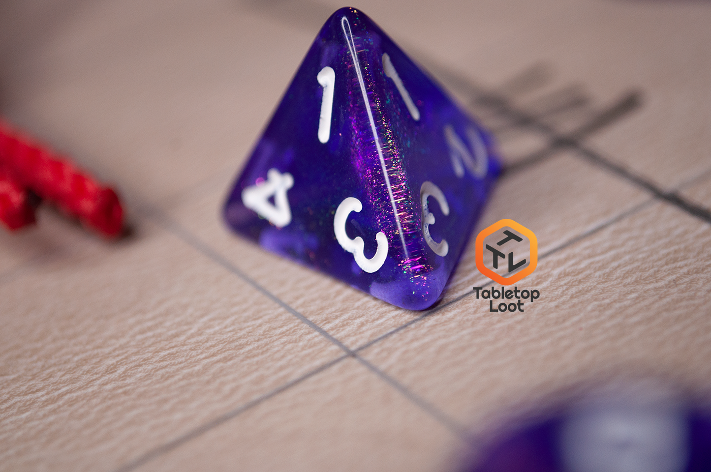 A close up of the D4 from the Diamond Purple 7 piece dice set from Tabletop Loot with purple dice filled with micro glitter and white numbering.