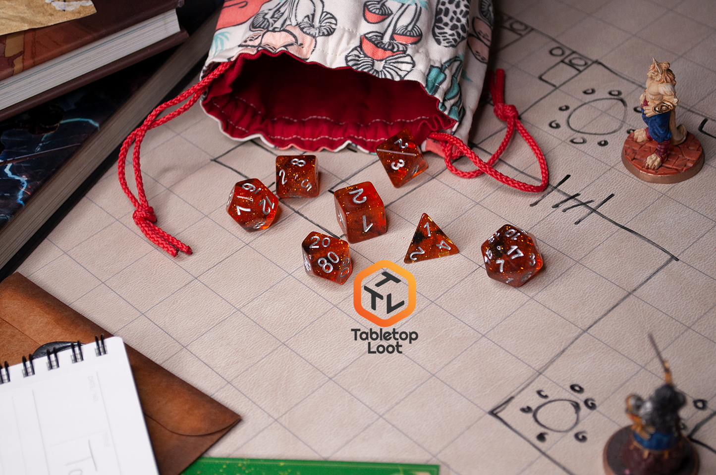 The Dissonant Whispers 7 piece dice set from Tabletop Loot with swirls of black in sparkling amber color, inked in silver, scattered across a game table.