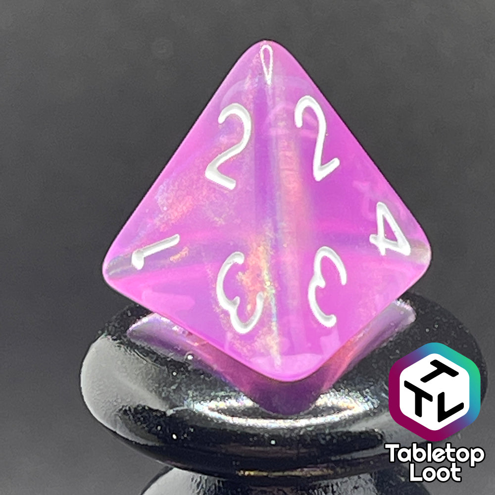 A close up of the D4 from the Dreamscapes 7 piece dice set from Tabletop Loot; pink with iridescent glitter and white numbering.