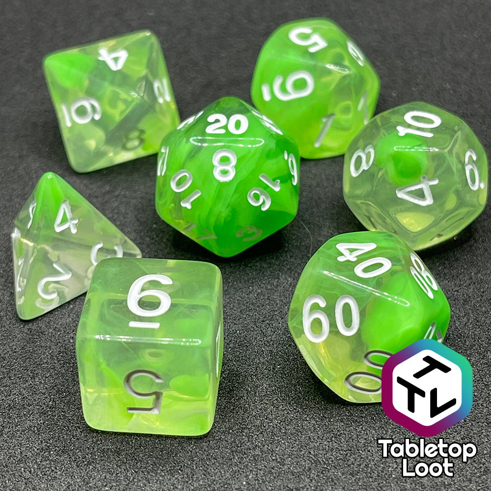 The Ectoplasm 7 piece dice set from Tabletop Loot with swirls of lime green in clear resin and white numbering.