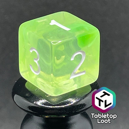 A close up of the D6 from the Ectoplasm 7 piece dice set from Tabletop Loot with swirls of lime green in clear resin and white numbering.
