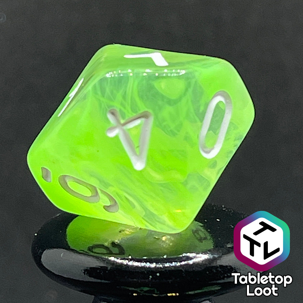 A close up of the D10 from the Ectoplasm 7 piece dice set from Tabletop Loot with swirls of lime green in clear resin and white numbering.