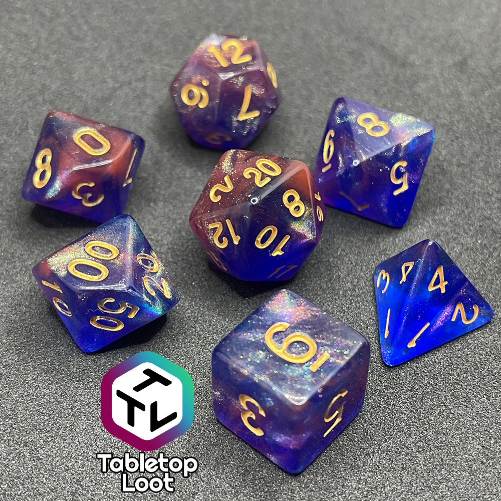 The Elvish Magic 7 piece dice set from Tabletop Loot with shimmering swirls of red, pink, and purple in blue with gold numbering.