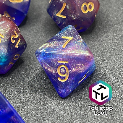 A close up of the D8 from the Elvish Magic 7 piece dice set from Tabletop Loot with shimmering swirls of red, pink, and purple in blue with gold numbering.