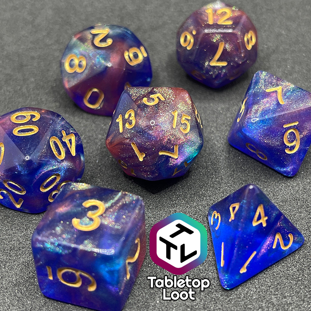 A close up of the Elvish Magic 7 piece dice set from Tabletop Loot with shimmering swirls of red, pink, and purple in blue with gold numbering.