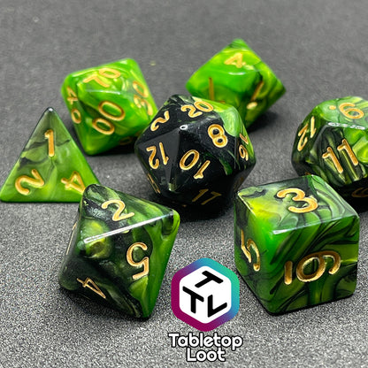 A close up of the Entangle 7 piece dice set from Tabletop Loot with swirls of pearlescent green and black and golden numbering.